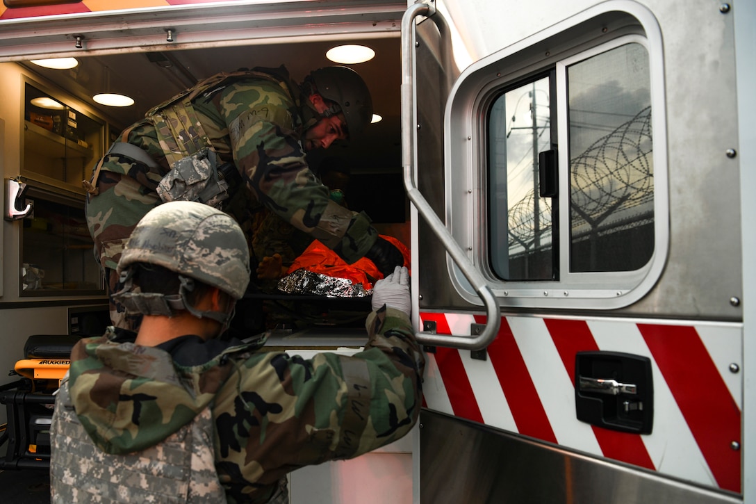 First responders from the 8th Fighter Wing tend to a simulated victim during routine training at Kunsan Air Base, Republic of Korea, Nov. 1, 2021. The 8th Medical Group supports the 8th Fighter Wing, and comprises the 8th Healthcare Operations Squadron (HCOS) and 8th Operational Medical Readiness Squadron OMRS. This support is executed by delivering preventive health services and outpatient medical care to over 2,800 base personnel. (U.S. Air Force photo by Staff Sgt. Jesenia Landaverde)