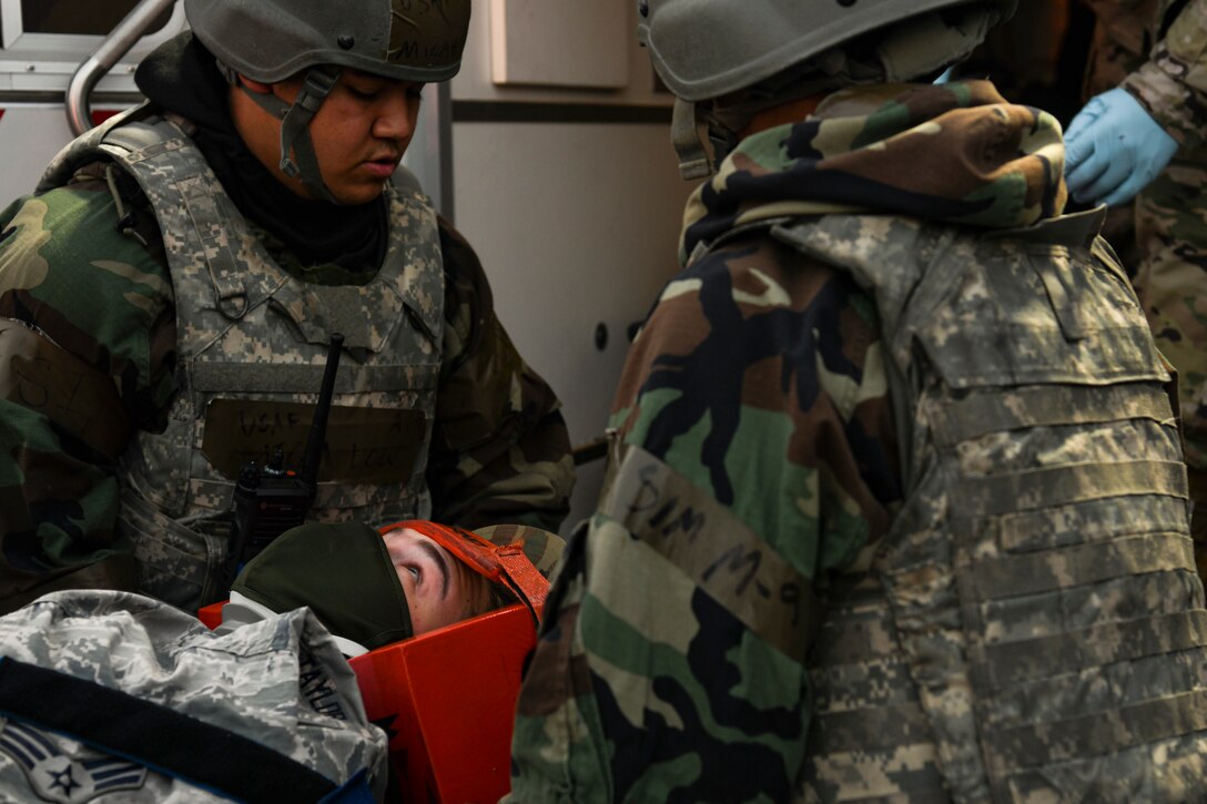 First responders assigned to the 8th Fighter Wing transport a simulated victim to safety during routine training at Kunsan Air Base, Republic of Korea, Nov. 1, 2021. The main priority for the Kunsan AB first responders, including the 8th CES firefighters and 8th MDG medical technicians, is to relocate injured personnel to safety to receive further medical treatment. (U.S. Air Force photo by Staff Sgt. Jesenia Landaverde)