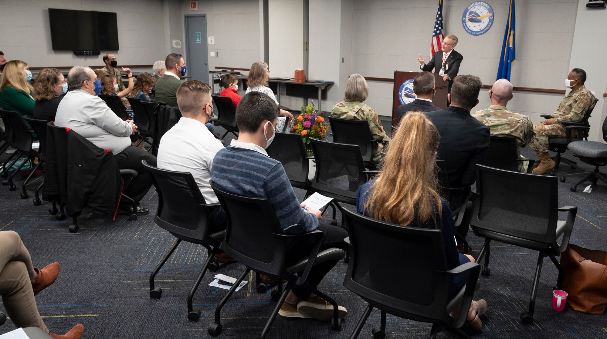 John Carr (standing behind podium), deputy director of the Agile Combat Support Directorate's Simulators Division, gives remarks during his retirement ceremony on at Wright-Patterson Air Force Base, Ohio, Oct. 29, 2021.