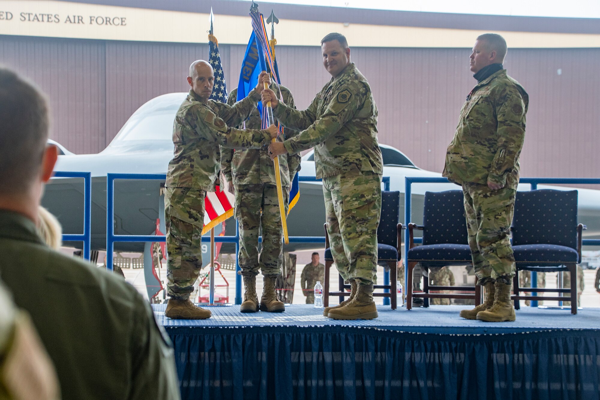 Outgoing 131st Maintenance Group Commander Col. Michael Belardo passes the group’s guidon to 131st Bomb Wing Commander Col. Matthew Calhoun during a change of command ceremony Oct. 2, 2021 at Whiteman Air Force Base, Missouri. Belardo was relieved by incoming Commander Lt. Col. Chad Larson. (U.S. Air National Guard photo by Staff Sgt. Joshua Colligan)