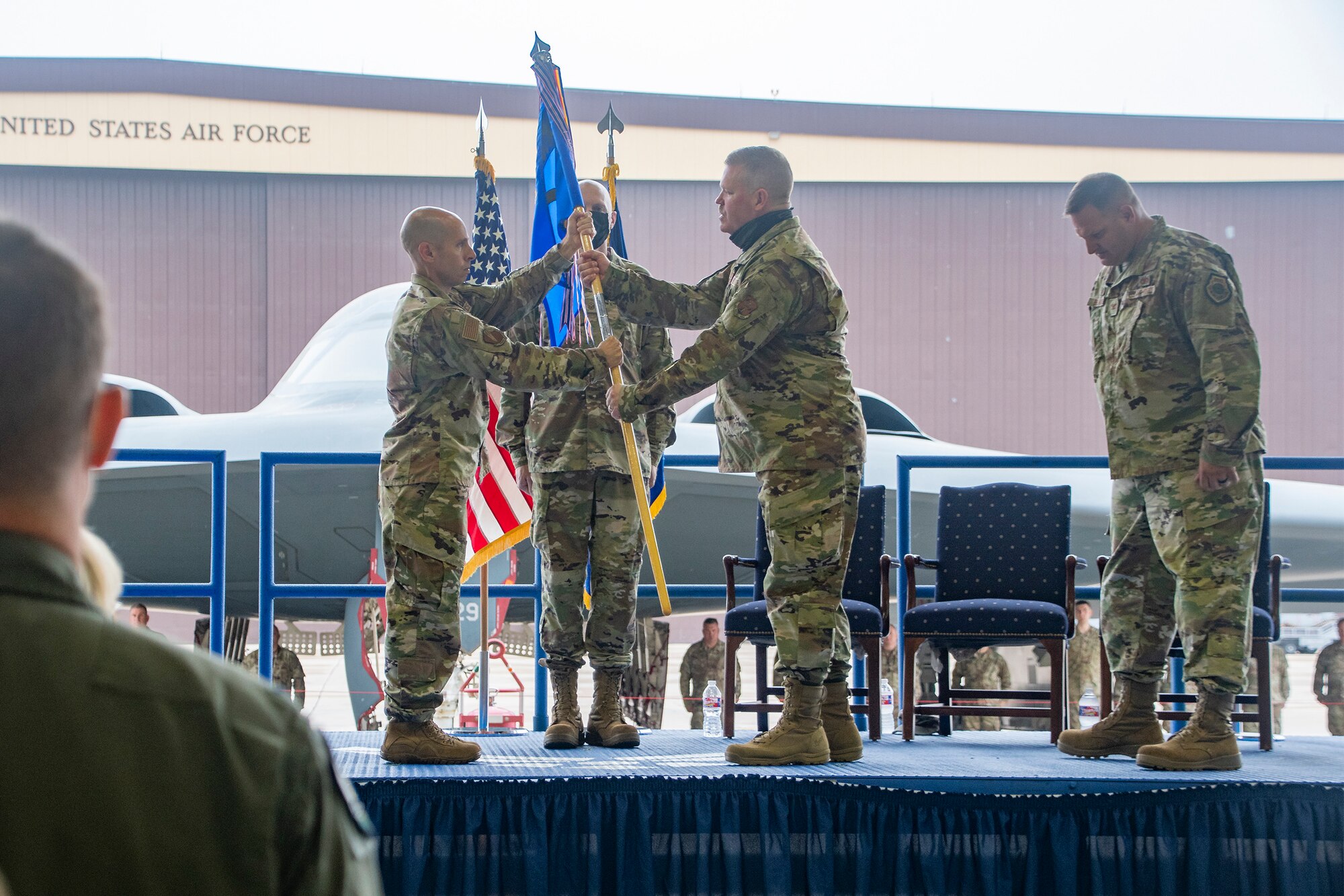 Incoming 131st Maintenance Group Commander Lt. Col. Chad Larson receives the group’s guidon from 131st Bomb Wing Commander Col. Matthew Calhoun during a change of command ceremony Oct. 2, 2021 at Whiteman Air Force Base, Missouri. Larson assumed command from Col. Michael Belardo. (U.S. Air National Guard photo by Staff Sgt. Joshua Colligan)