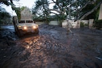 Sgt. Jose Paiz of the 1114th Composite Truck Company, California National Guard, walks back to a Humvee, Jan. 12, 2018, after checking the depth of mud down the street during a rescue mission in Montecito, California. The 1114th rescued or evacuated more than 1,800 people in the Montecito area following a deadly mudslide that struck the city in the predawn hours Jan. 9.