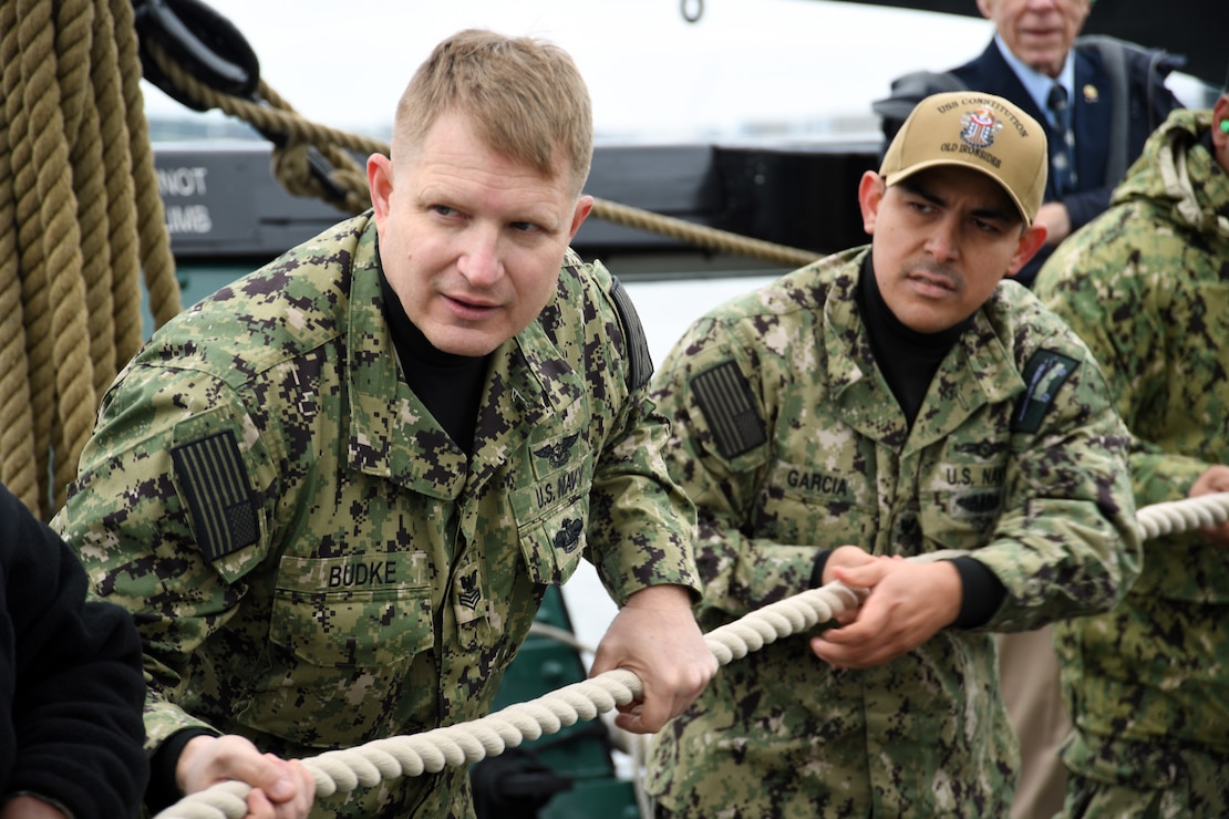 Chief petty officer (CPO) selectees conduct line handling operations during CPO Heritage Week on board the USS Constitution.