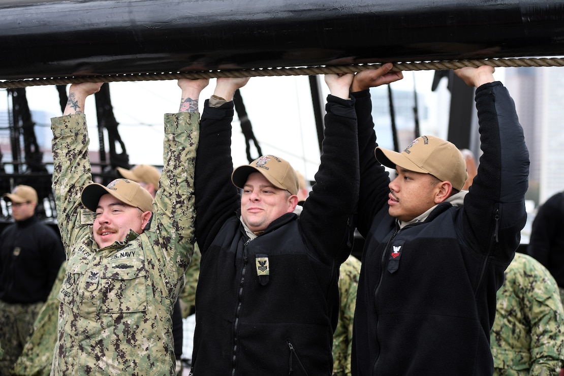 Chief petty officer (CPO) selectees conduct line handling operations during CPO Heritage Week on board the USS Constitution.