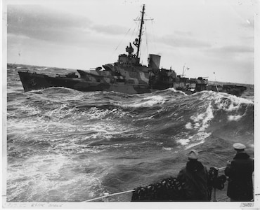 "Camouflaged 327-ft. U.S. Coast Guard Cutter DUANE (WPG-33) ploughs heavy seas in search of Nazi undersea marauders to protect a convoy of supply ships crossing the North Atlantic to the Mediterranean war zone