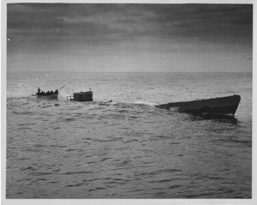 "Coast Guardsmen from the cutter SPENCER picking up survivors from the Nazi U-Boat just before it made its final dive.  Meanwhile the convoy steamed on."