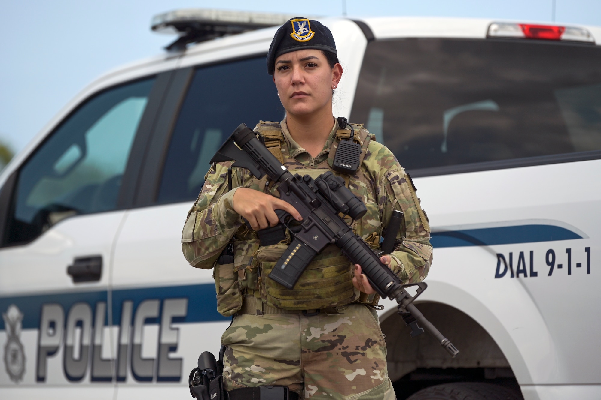 U.S. Air Force Airman 1st Class Kenia Coreano, a Security Forces journeyman with the 156th Security Forces Squadron, holds a weapon beside a patrol vehicle, Oct. 26, 2021 at Muñiz Air National Guard Base, Puerto Rico Air National Guard. Coreano was selected as the November spotlight for her merits and performance as a security forces defender. (U.S. Air National Guard photo by Tech. Sgt. Rafael D. Rosa)