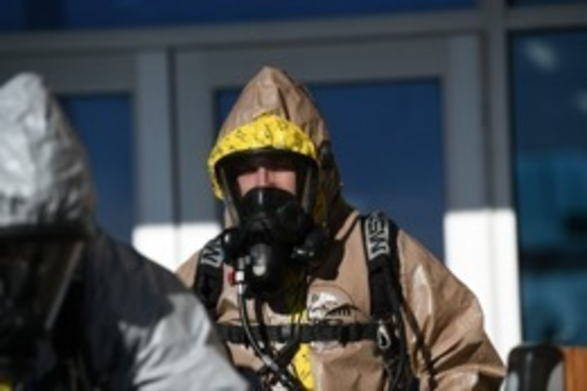 A man in full bio chemical gear walking
