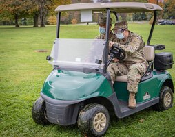 Soldiers drive golf kart