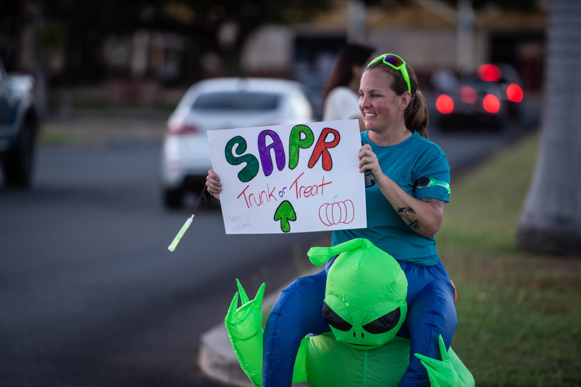 Petty Officer Second Class Tamya Stemple, Construction Battalion Maintenance Unit 303 steelworker, welcomes trick-or-treaters during “The Trunk of Treats” event at Joint Base Pearl Harbor-Hickam, Hawaii, Oct. 29, 2021. The family oritented event was hosted by the 15th Wing Sexual Assault Prevention and Response Team. (U.S. Air Force photo by Senior Airman Alan Ricker)