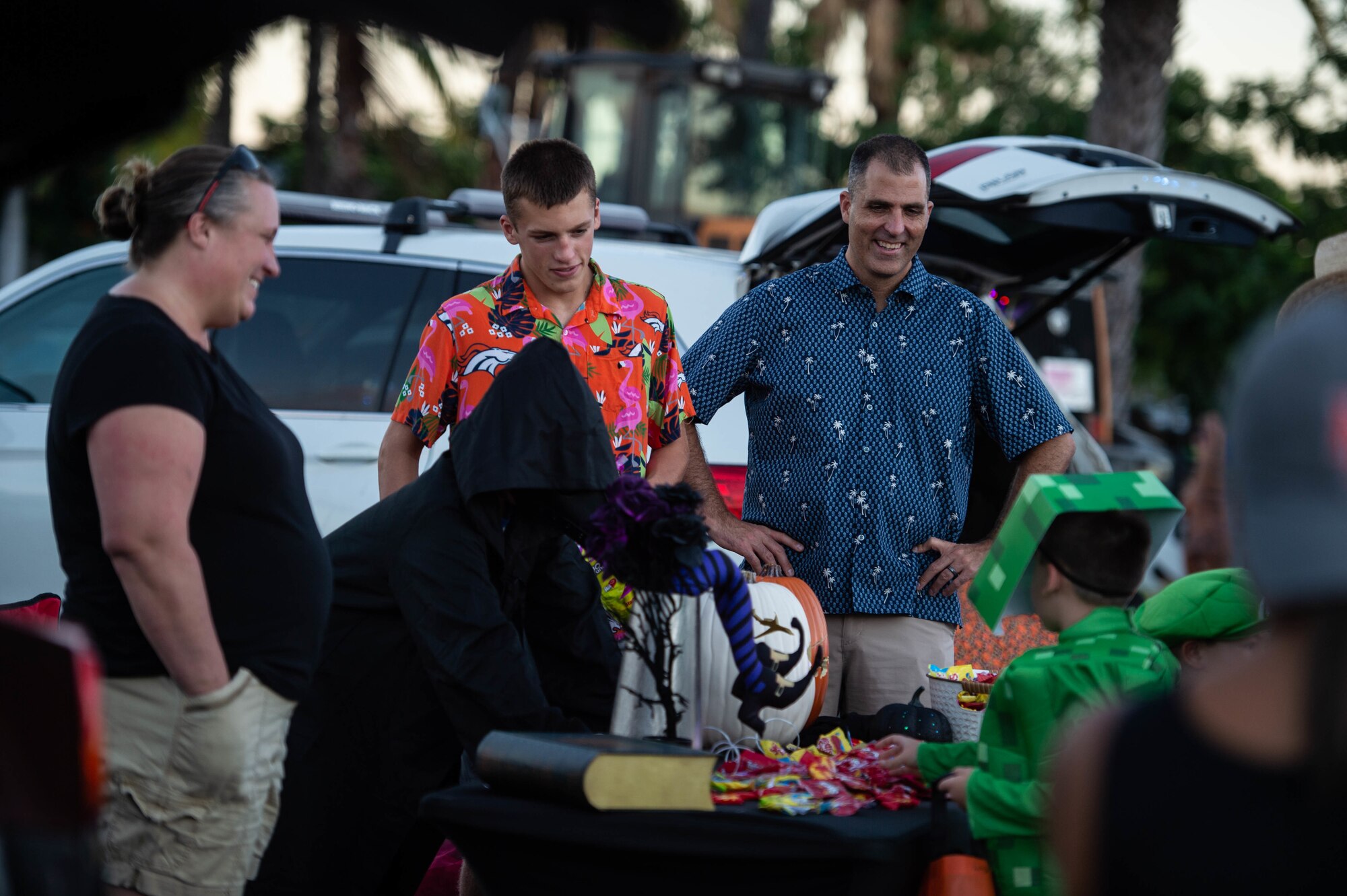 Col. Daniel Dobbels, 15th Wing commander, and his family, welcome trick-or-treaters to “The Trunk of Treats” event at Joint Base Pearl Harbor-Hickam, Hawaii, Oct. 29, 2021. The event provided a safe and fun way for children of the military and civilian employee community to trick or treat. (U.S. Air Force photo by Senior Airman Alan Ricker)