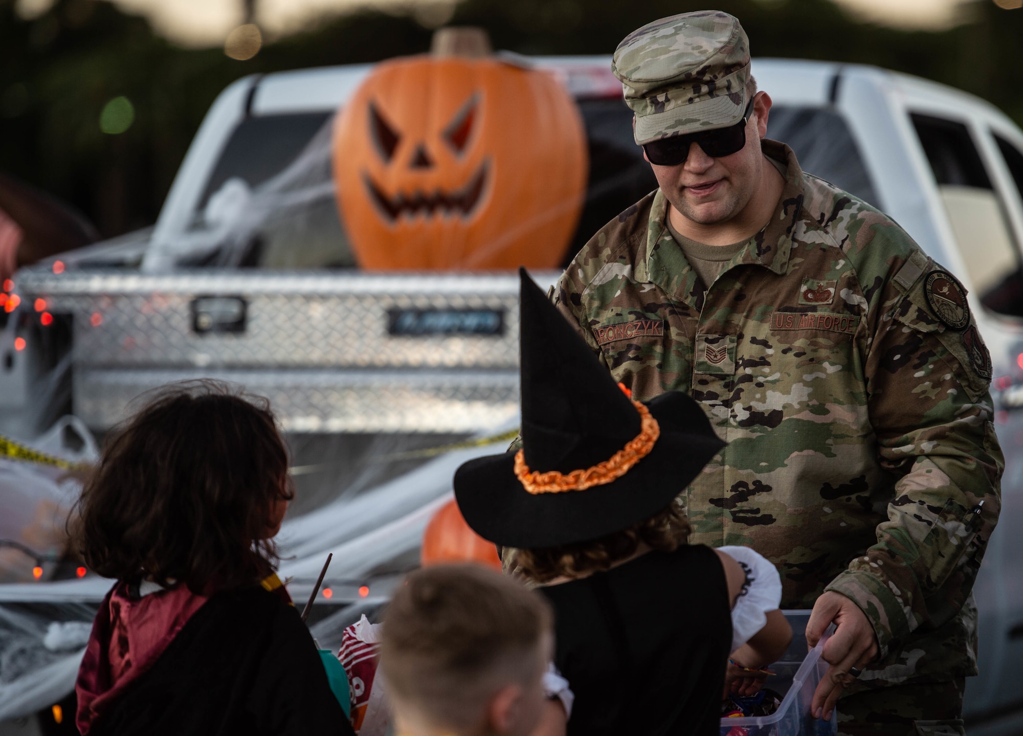 Tech. Sgt. David Yaronczyk, Chief Master Sgt. of the Air Force James C. Binnicker Professional Military Education Center instructor, gives out candy to trick-or-treaters during “The Trunk of Treats'' event at Joint Base Pearl Harbor-Hickam, Hawaii, Oct. 29, 2021. Yaronczyk, along with his Airmen that are currently enrolled in Airman Leadership School, Flight 22A, passed out sweets. (U.S. Air Force photo by Senior Airman Alan Ricker)