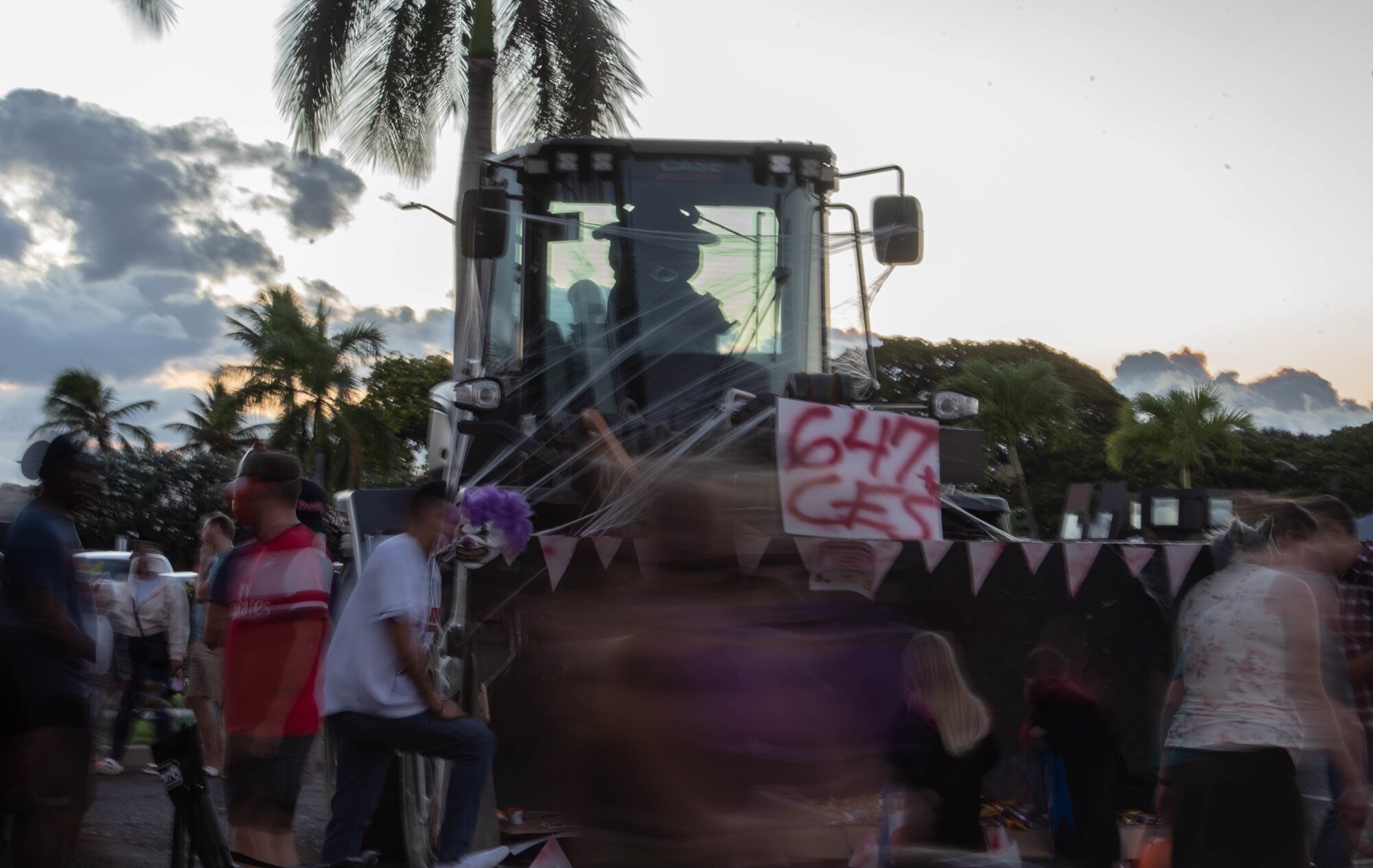 Trick-or-treaters walk past the 647th Civil Engineer Squadron’s loader display during “The Trunk of Treats” event at Joint Base Pearl Harbor-Hickam, Hawaii, Oct. 29, 2021. Military and civilian volunteers decorated their vehicles during the event, dressed up in costumes and handed out candy to multiple trick-or-treaters. (U.S. Air Force photo by Senior Airman Alan Ricker)