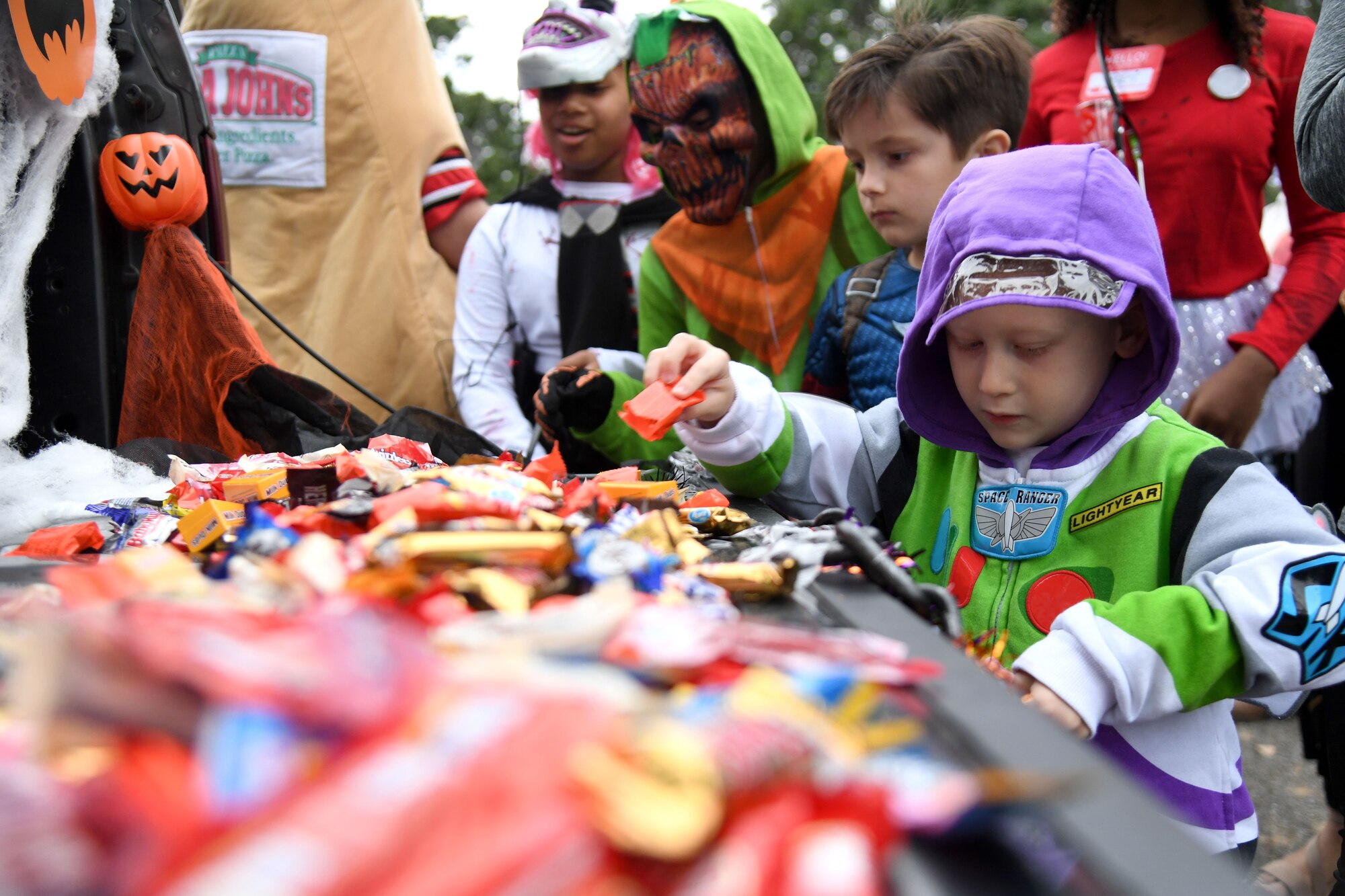 Elijah Mier, son of U.S. Air Force Staff Sgt. Victoria Mier, 81st Dental Squadron dental hygienist, collects candy during Ghouls in the Park at the marina park on Keesler Air Force Base, Mississippi, Oct. 29, 2021. The Halloween event also featured a haunted house, a boo bus and various games for children of all ages. (U.S. Air Force photo by Kemberly Groue)