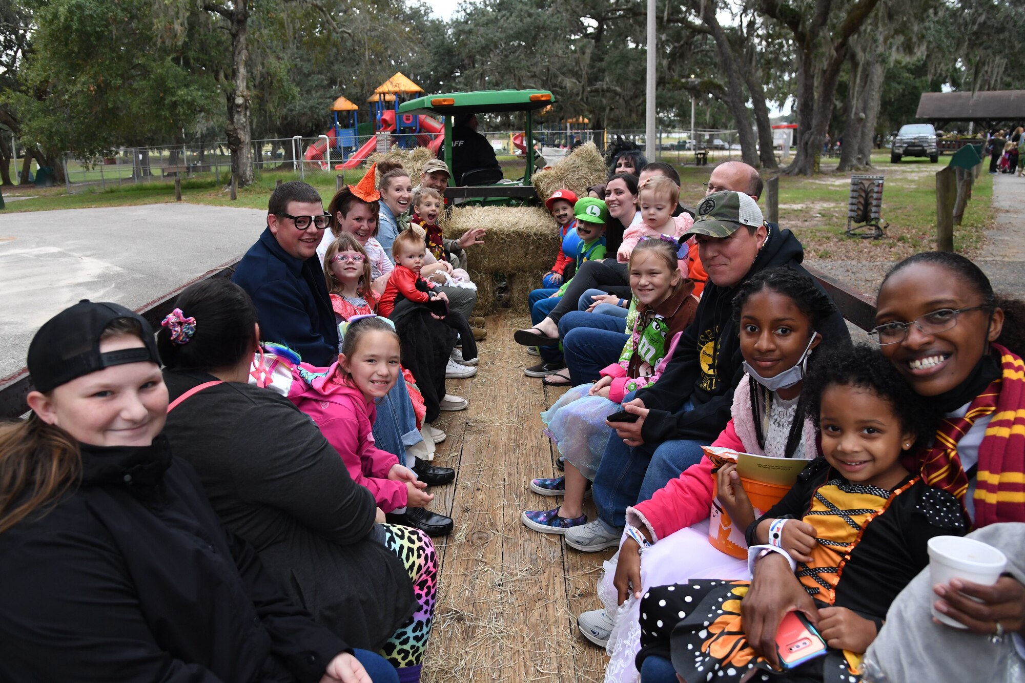 Keesler families participate in a hay ride during Ghouls in the Park at the marina park on Keesler Air Force Base, Mississippi, Oct. 29, 2021. The Halloween event also featured a haunted house, trunk-or-treat and various games for children of all ages. (U.S. Air Force photo by Kemberly Groue)