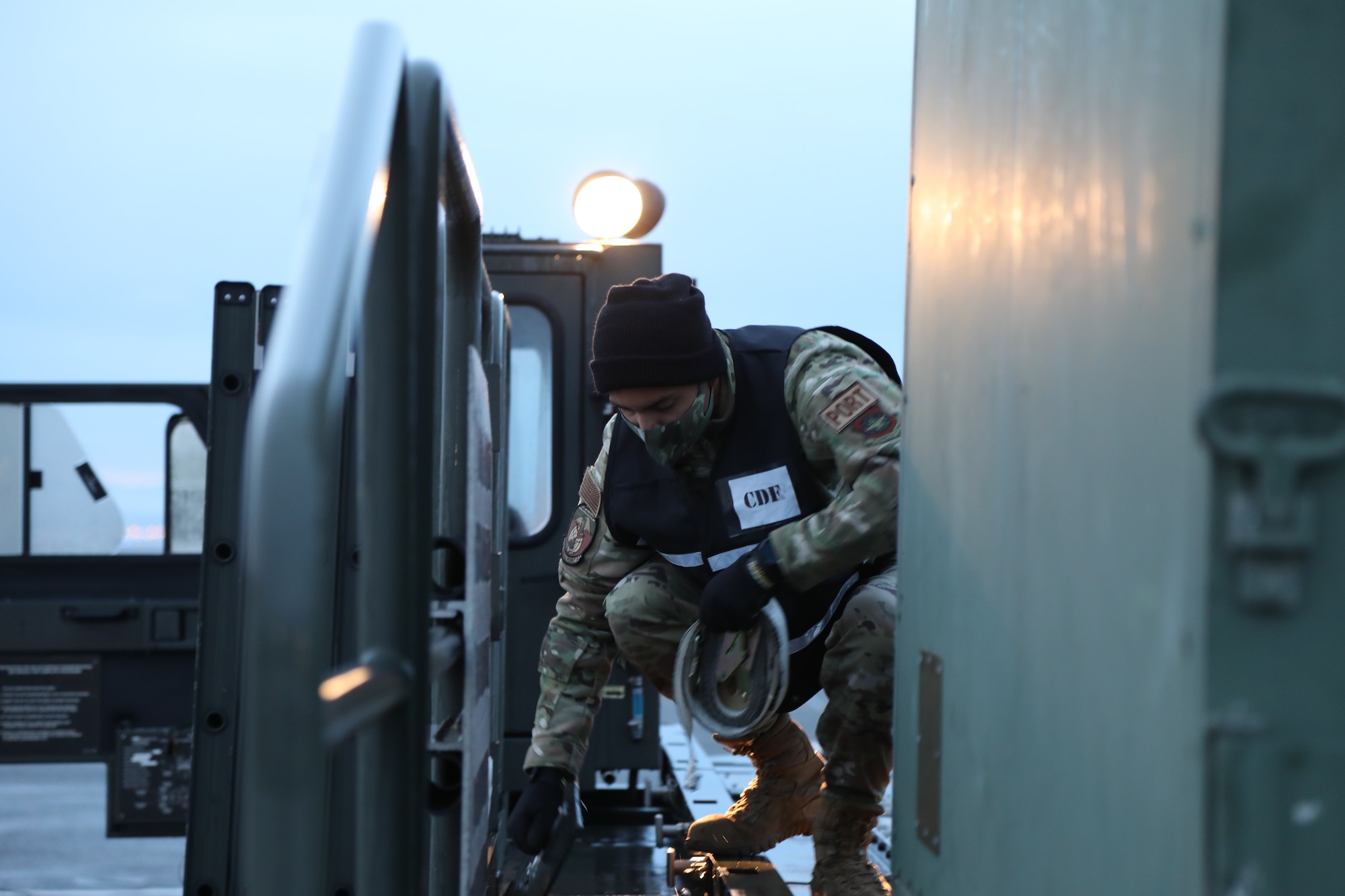 U.S. Air Force Tech. Sgt. Jereme Henson, 62nd Aerial Port Squadron non-commissioned officer in charge of cargo processing, assists with moving cargo on a Halvorsen 25k loader during Exercise Rainier War 21B at Joint Base Lewis-McChord, Washington, November 2, 2021. The exercise is designed to demonstrate the wing’s ability to operate and survive while defeating challenges to the U.S. military advantage in all operating domains – air, land, sea and cyberspace. (U.S. Air Force photo by Senior Airman Christopher Sommers)