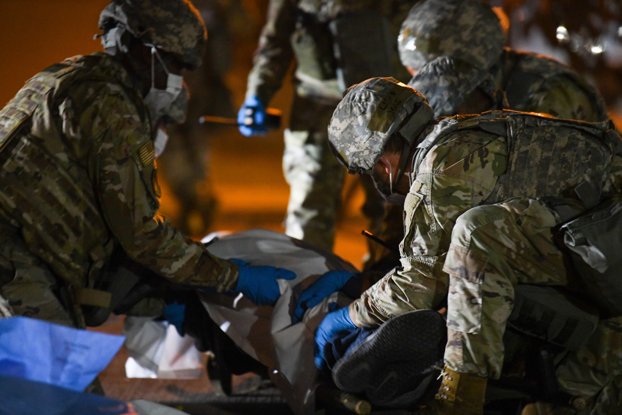 Augmentees transfer simulated human remains during a Samurai Readiness Inspection exercise