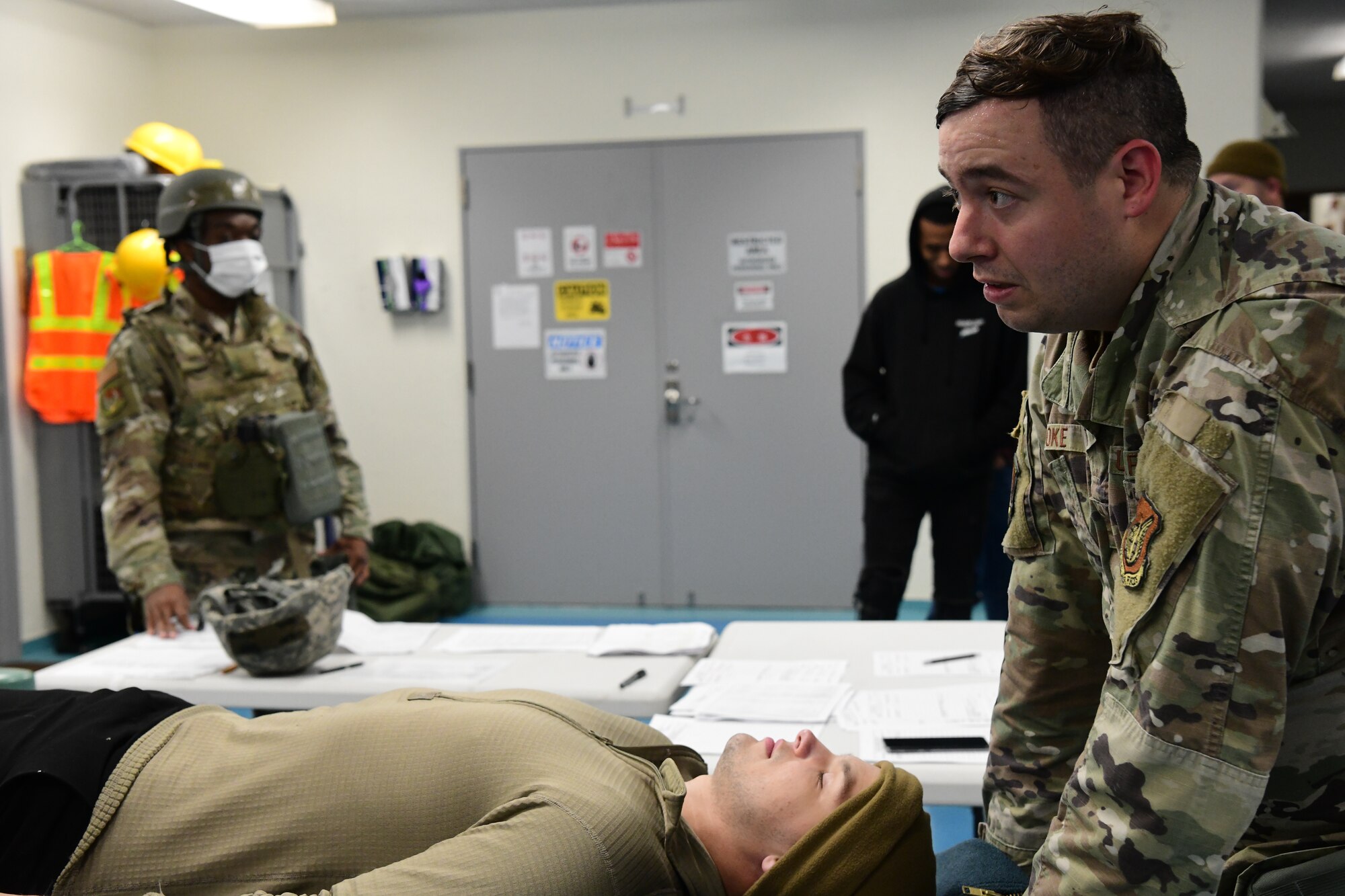 Mortuary Affairs augmentee, transports a simulated casualty through mortuary