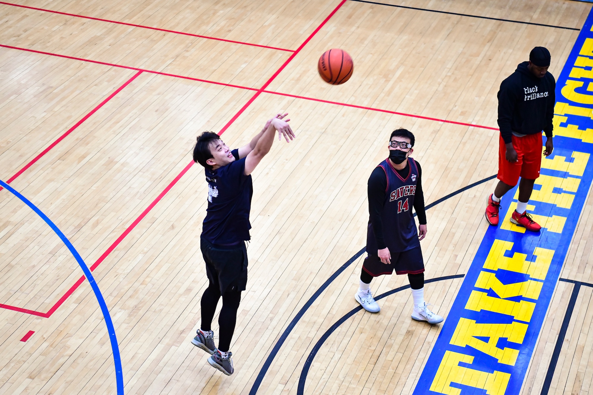 A ROK Airman shooting a basket.