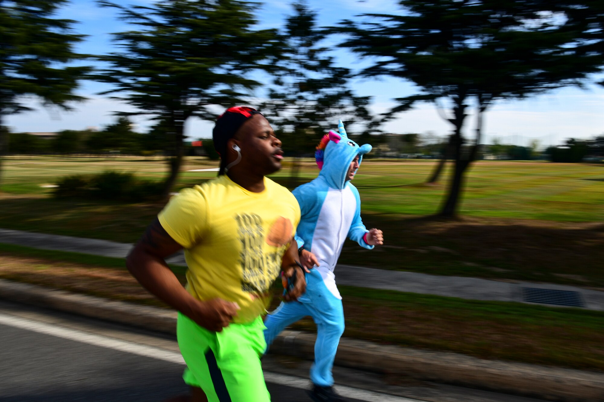 Two Airmen running alongside each other.
