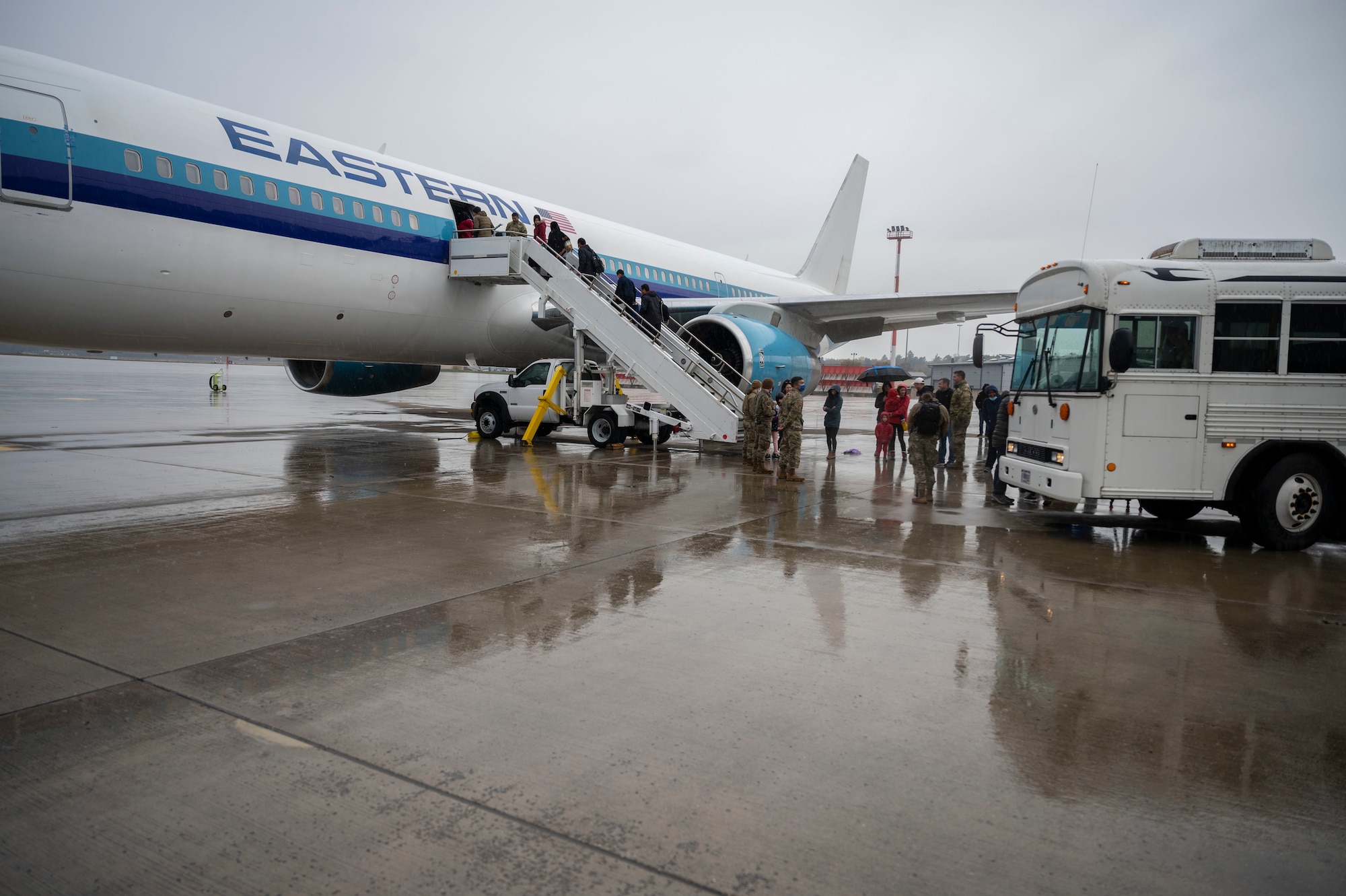 Afghan evacuees board the final flight to the United States from Ramstein Air Base, Germany, Oct. 30, 2021. More than 34,800 Afghan evacuees traveled through Ramstein since Aug. 20, as part of the Department of State-led noncombatant evacuation operation. This flight marked the completion of Ramstein’s role in the largest humanitarian airlift in history. (U.S. Air Force photo by Senior Airman Milton Hamilton)