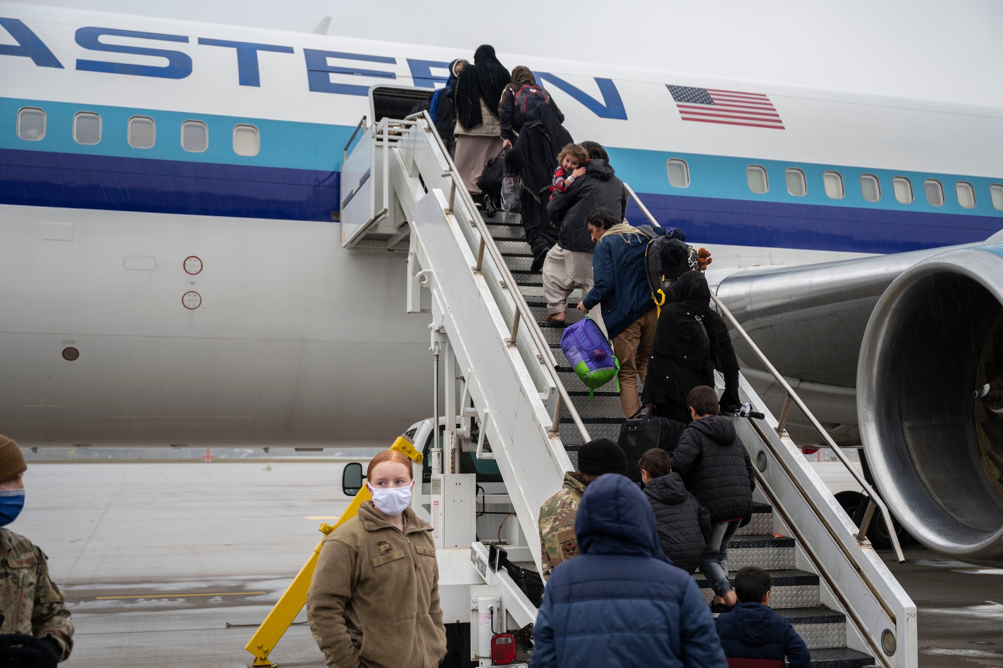 Afghan evacuees board the final outbound flight to the United States from Ramstein Air Base, Germany, Oct. 30, 2021. Intelligence, law enforcement, and counterterrorism professionals conducted screening and security vetting for all Afghans prior to their departure. This flight marked the completion of Ramstein’s role in the largest humanitarian airlift in history.  (U.S. Air Force photo by Senior Airman Milton Hamilton)