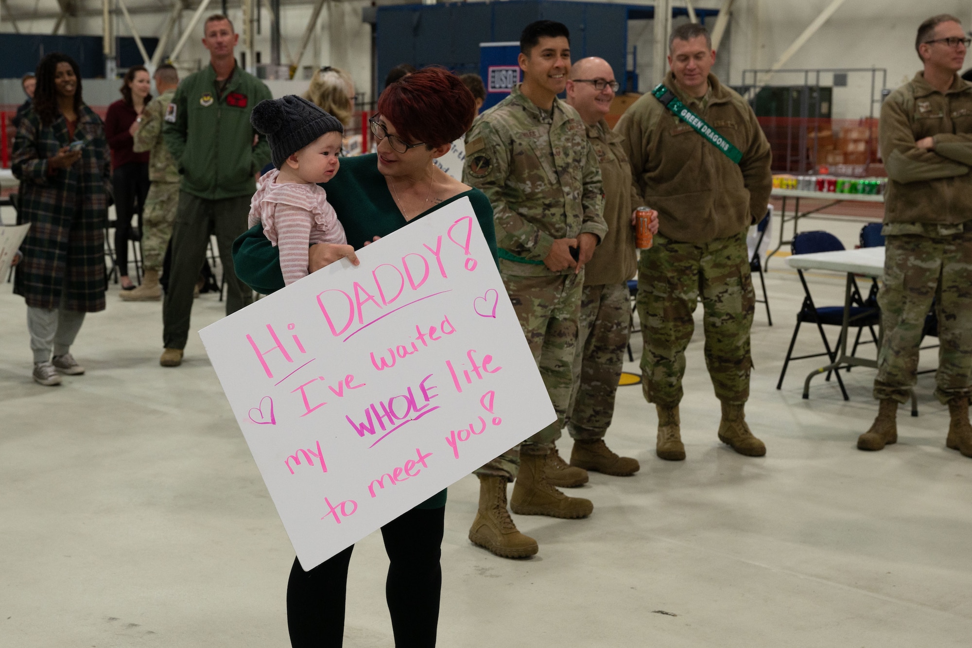 A family of a deployed 48th Fighter Wing Airman wait to welcome them home at Royal Air Force Lakenheath, England, after being away for eight months in an undisclosed location in Southwest Asia, Nov. 2, 2021. While conducting operations in support of Operation Inherent Resolve, the Panthers simultaneously flew their F-15E Strike Eagles in support of Operation Final Countdown and Operation Allies Welcome. (U.S. Air Force photo by Airman 1st Class Cedrique Oldaker)