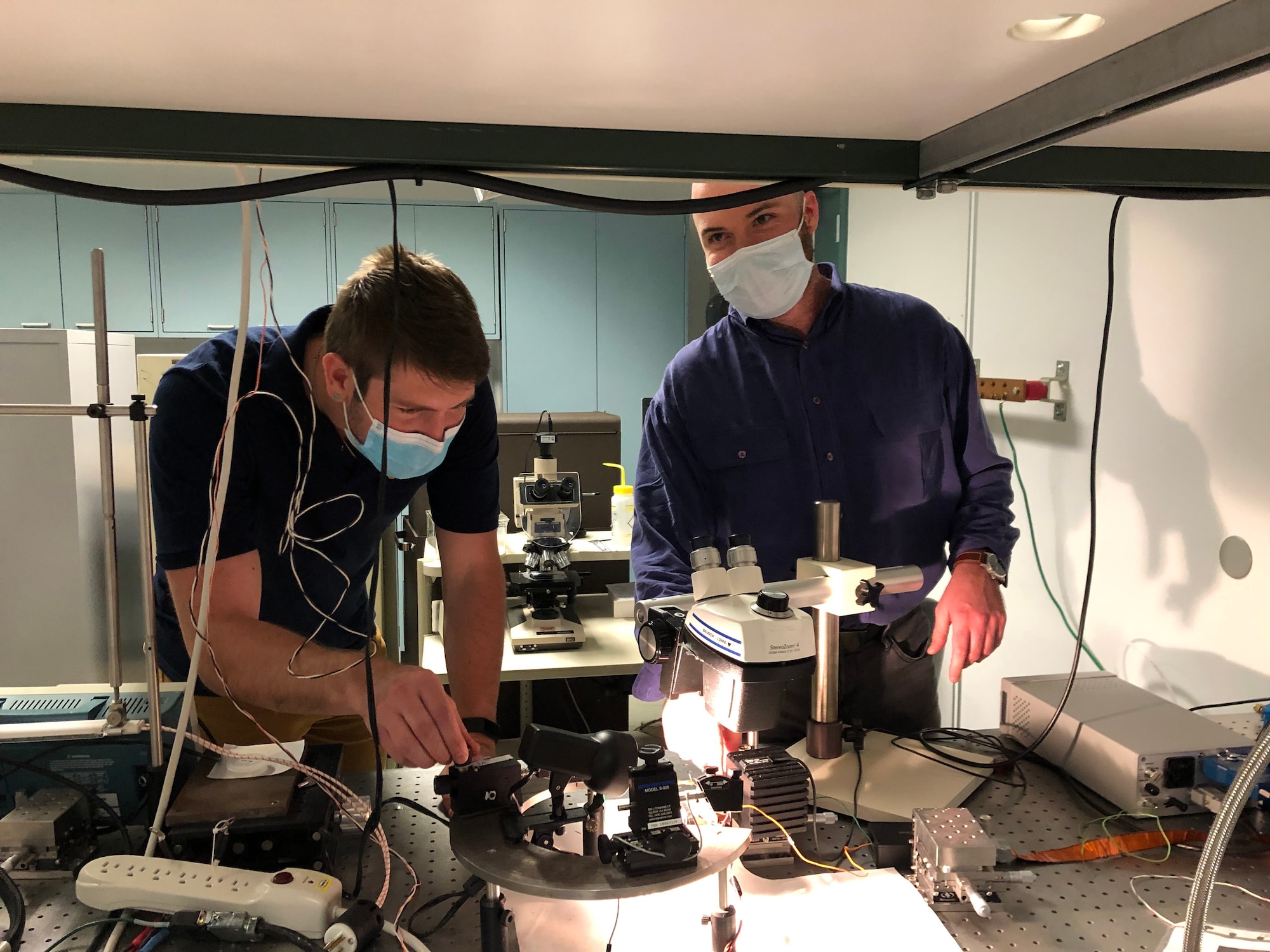 Graduate students Alex Newell (left) and Kevin Reilly (right) characterizing a semiconductor diode laser. (UNM Courtesy Photo)