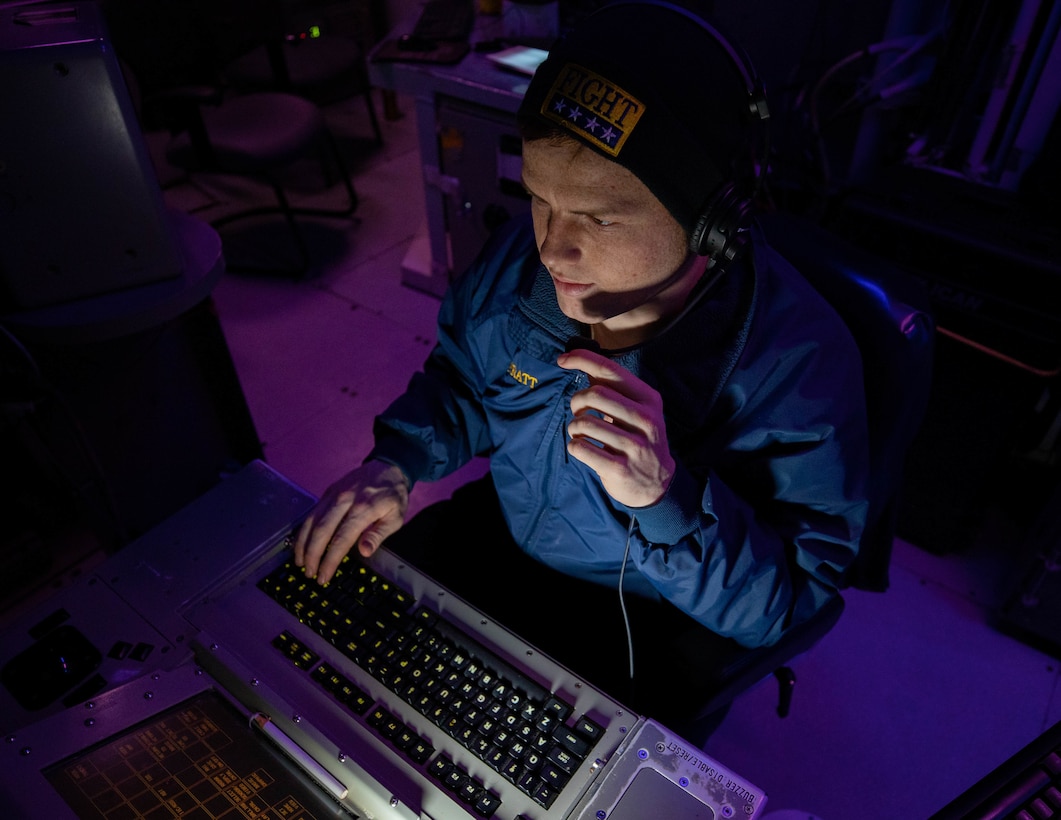 Operations Specialist 2nd Class Brandon Pratt, from Kenosha, Wisc., stands the Tactical Information Coordinator watch in the Combat Information Center aboard the Arleigh Burke-class guided-missile destroyer USS Dewey (DDG 105).