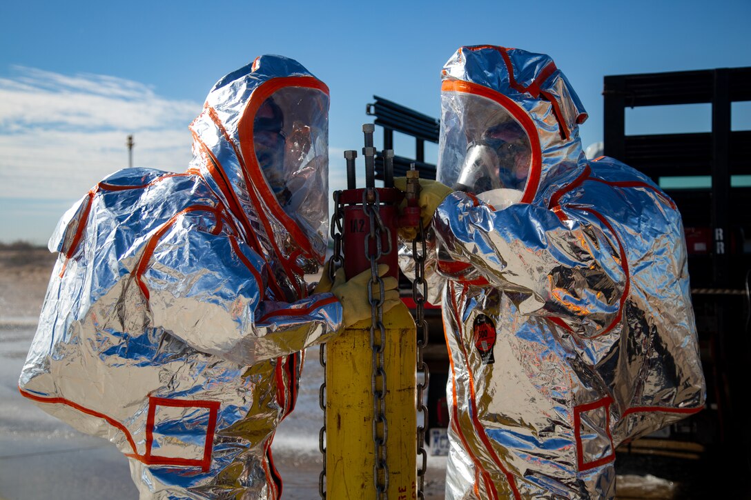 Fire Fighters with Marine Corps Air Station (MCAS) Yuma, Ariz. neutralize a simulated gas leak during exercise Desert Plume, Nov. 2, 2021. Desert Plume is a training event that evaluates MCAS Yuma’s ability to respond to a CBRNE/HAZMAT incident quickly and efficiently. (U.S. Marine Corps photo by Cpl. Gabrielle Sanders)