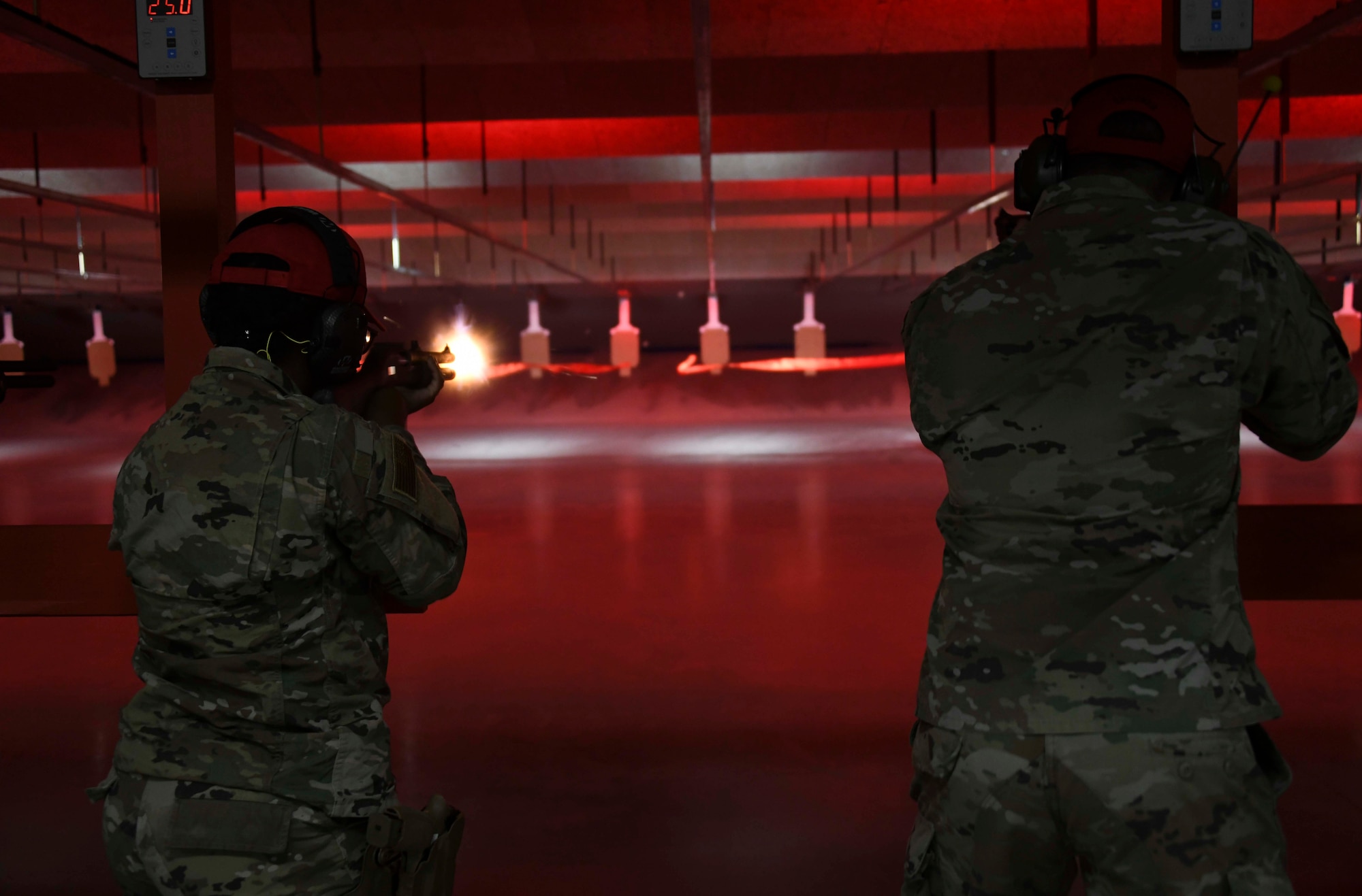 Staff Sgt. Victory Bell, 316th Security Support Squadron combat arms instructor, fires at a ribbon to signify the opening of the new Combat Arms Training and Maintenance facility shooting range at Joint Base Andrews, Md., Nov. 1, 2021. The CATM instructors were selected to be the first to fire on the new range. (U.S. Air Force photo by Senior Airman Spencer Slocum)