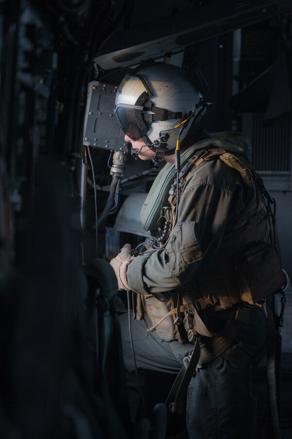 U.S. Marine Corps Lance Cpl. Dwight Daigle, a crew chief with Marine Heavy Helicopter Squadron 772, Marine Aircraft Group 49, Marine Forces Reserve, observes a CH-53E Super Stallion while flying over Mississippi during exercise Raven 22-2, Oct. 24, 2021. Exercise Raven facilitated joint training with active and reserve component Marines, enabling a more capable and ready reserve force. (U.S. Marine Corps photo by Cpl. Brendan Mullin)