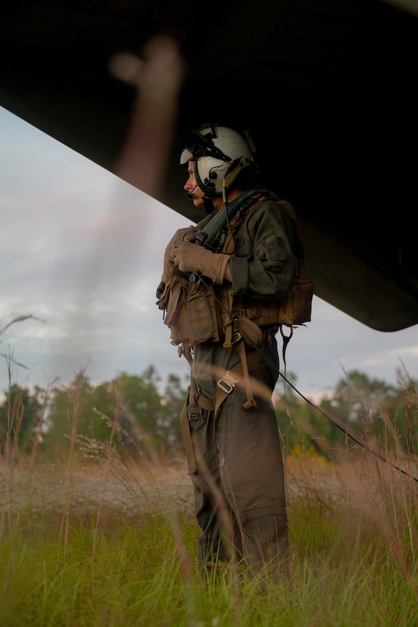U.S. Marine Corps Lance Cpl. Dwight Daigle, a crew chief with Marine Heavy Helicopter Squadron 772, Marine Aircraft Group 49, Marine Forces Reserve, observes a CH-53E Super Stallion while flying over Mississippi during exercise Raven 22-2, Oct. 24, 2021. Exercise Raven facilitated joint training with active and reserve component Marines, enabling a more capable and ready reserve force. (U.S. Marine Corps photo by Cpl. Brendan Mullin)