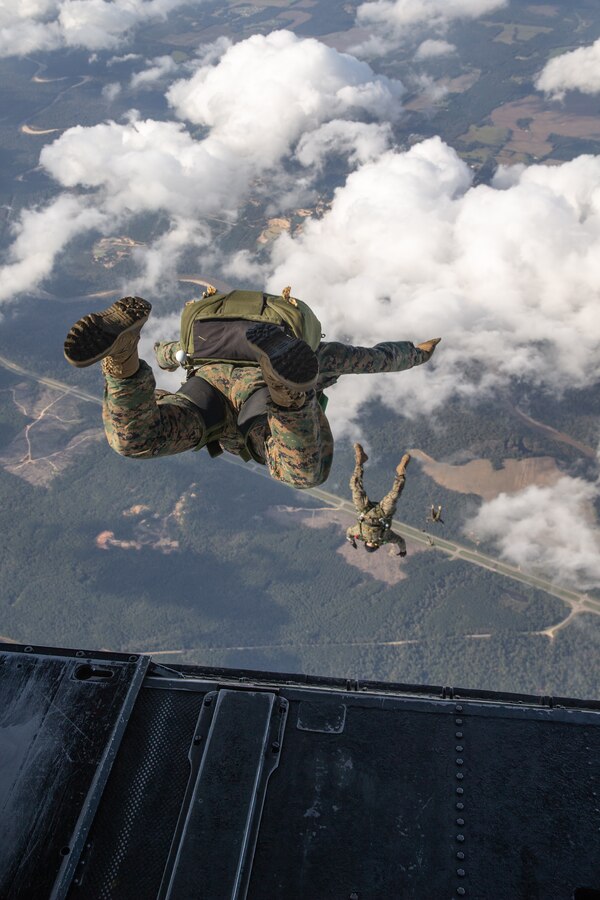 U.S. Marines with 3d Force Reconnaissance Company, 4th Recon Battalion, jump from a CH-53E Super Stallion with Marine Heavy Helicopter Squadron 772, Marine Aircraft Group 49, Marine Forces Reserve, while conducting military free-fall training over Mississippi during exercise Raven 22-2, Oct. 25, 2021. Raven is a routine exercise that provides MARSOC Marines with realistic, specialized training that will prepare them for various situations they may encounter while deployed. (U.S. Marine Corps photo by Cpl. Brendan Mullin)