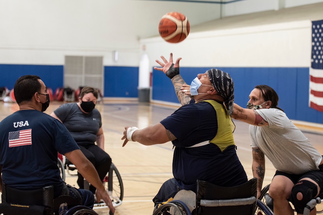 Navy athletes practice wheelchair basketball.