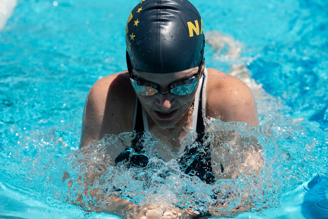 A Navy athlete practices the breast stroke during swim practice.