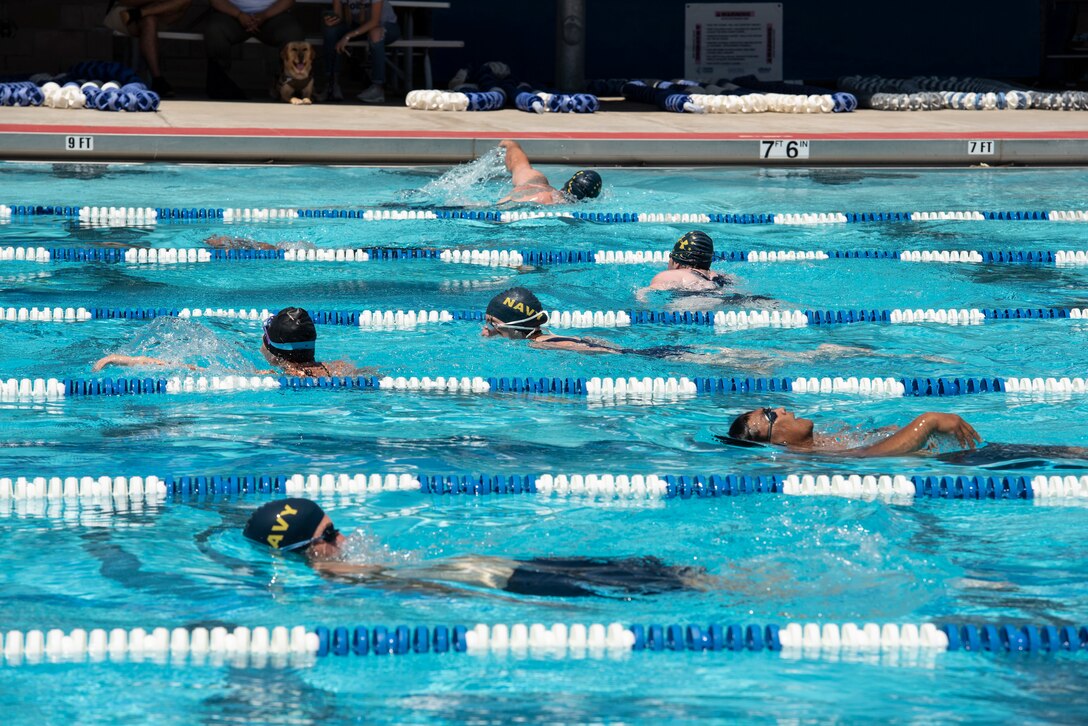 Navy athletes participate in swim practice.