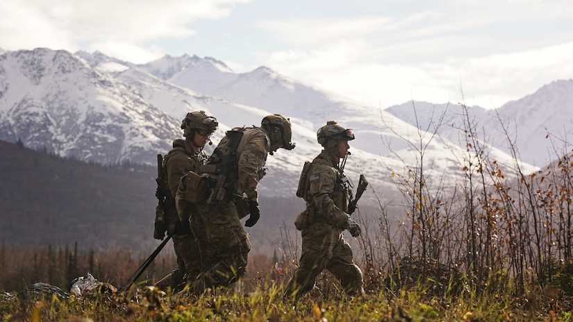 Alaska Air National Guardsmen assigned to the 212th Rescue Squadron, 176th Wing, make their way back to a staging area after loading patients on an Alaska Army National Guard UH-60L Black Hawk helicopter while conducting a full mission profile exercise at Joint Base Elmendorf-Richardson, Alaska, Oct. 13, 2021. The busiest rescue force in the Department of Defense, the 212th RQS provides elite pararescuemen and combat rescue officers that are uniquely skilled in integrating air and ground capabilities to carry out the 176th Wing’s wartime and peacetime personnel recovery missions. (U.S. Army National photo by Dana Rosso)