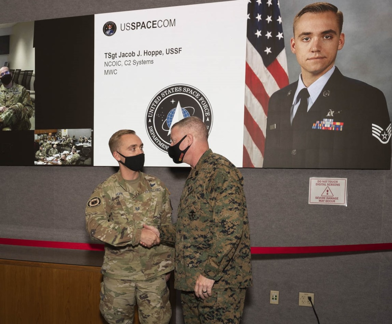 U.S. Marine Corps Master Gunnery Sgt. Scott Stalker (right), U.S. Space Command command senior enlisted leader, congratulates U.S. Space Force Tech Sgt. Jacob Hoppe (left) of the Combined Force Space Component Command’s Missile Warning Center as a “Star of USSPACECOM” on Oct. 28, 2021, at the 2021 Fall Commander’s Conference at Peterson Space Force Base, Colorado. U.S. Army Gen. James Dickinson, USSPACECOM commander, and Stalker recognized personnel across the command, its service components and subordinate units. One of USSPACECOM’s priorities is developing warfighters who understand the threats in all domains — air, land, sea, cyber and space — so they can respond decisively.
