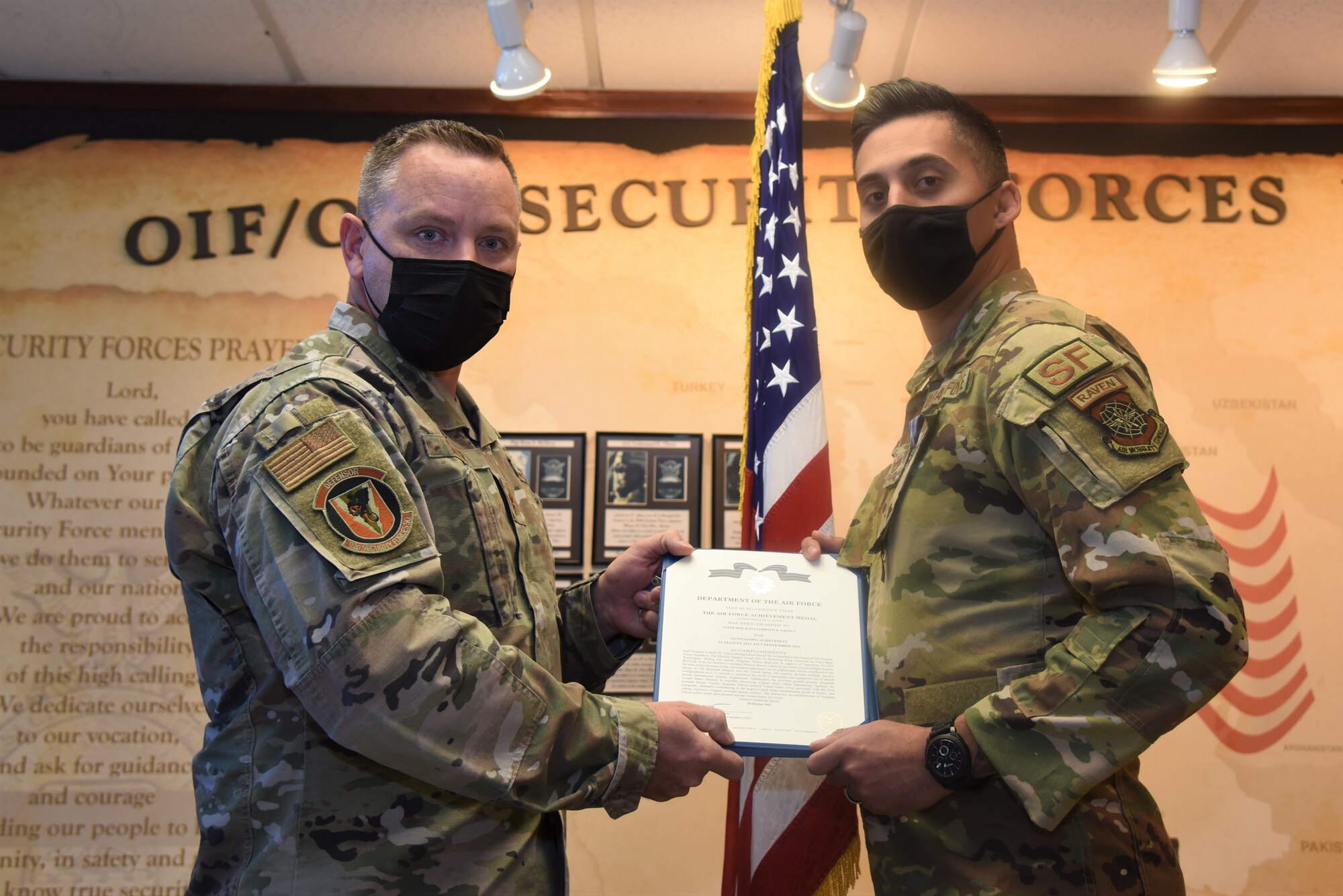 92nd Security Forces Squadron commander awards the Air Force Achievement Medal to U.S. Air Force Staff Sgt. Lorenzo Tafoya, 92nd SFS flight sergeant and Phoenix Raven.