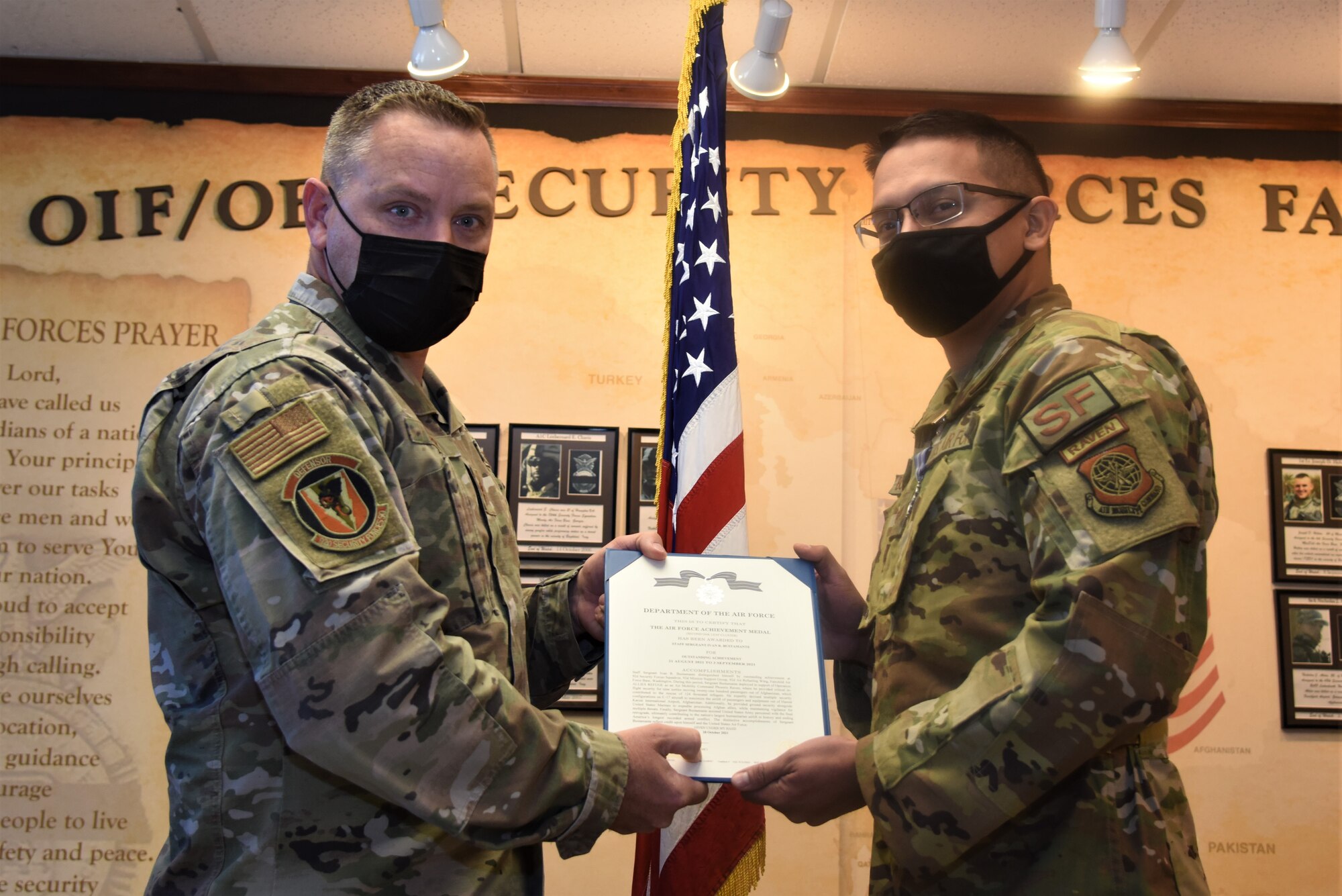 92nd Security Forces Squadron commander awards the Air Force Achievement Medal to U.S. Air Force Staff Sgt. Ivan Bustamante, 92nd SFS Standards and Evaluation noncommissioned officer and Phoenix Raven.
