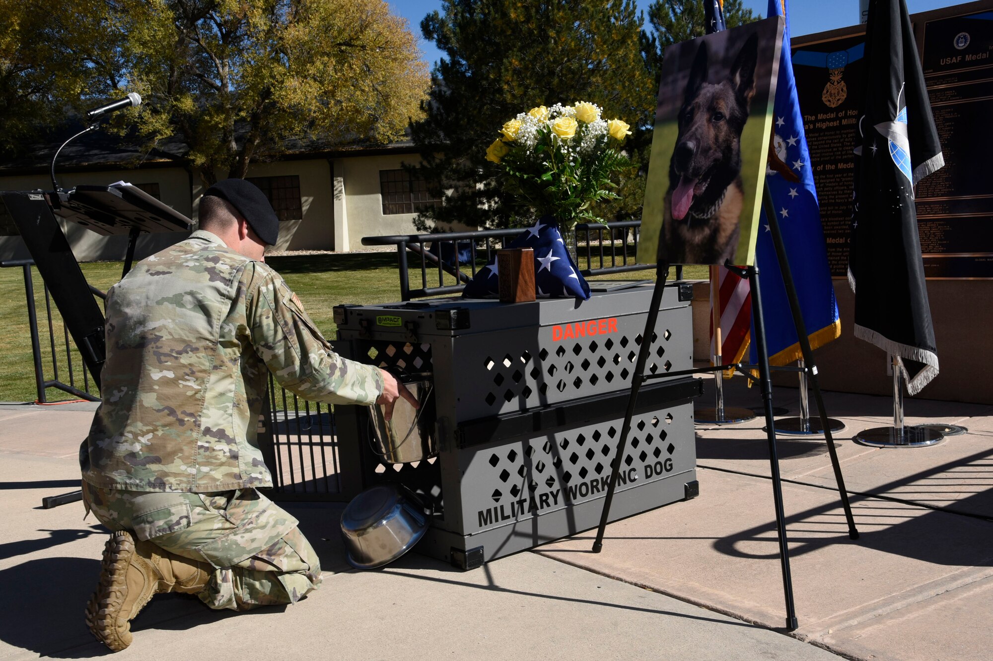 Tech. Sgt. Konnor Torkelson, 21st Security Forces Squadron military working dog handler, places MWD Rexo’s leash, chain and empty dishes inside his kennel during his memorial ceremony