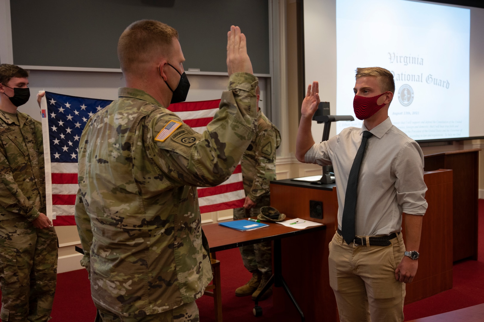 Cadet Ethan Pulkit swears into the Virginia Army National Guard in front of family, friends and peers during a ceremony held Aug. 20, 2021, at Christopher Newport University McMurran Hall, Newport News, Virginia. With more than 200 years of combined family service in the National Guard, Pulket will be following in his family's footsteps and be part of the 4th generation to continue the legacy of military service to the nation and the 29th ID. (U.S. Army National Guard photo by Staff Sgt. Lisa M. Sadler)