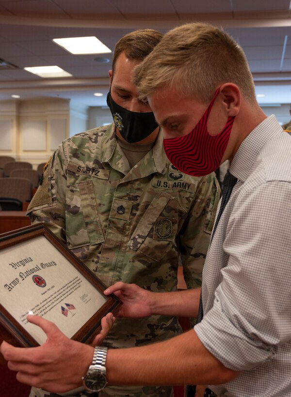 Cadet Ethan Pulkit swears into the Virginia Army National Guard in front of family, friends and peers during a ceremony held Aug. 20, 2021, at Christopher Newport University McMurran Hall, Newport News, Virginia. With more than 200 years of combined family service in the National Guard, Pulket will be following in his family's footsteps and be part of the 4th generation to continue the legacy of military service to the nation and the 29th ID. (U.S. Army National Guard photo by Staff Sgt. Lisa M. Sadler)