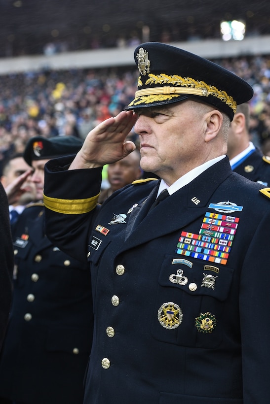 A man in a military uniform salutes.