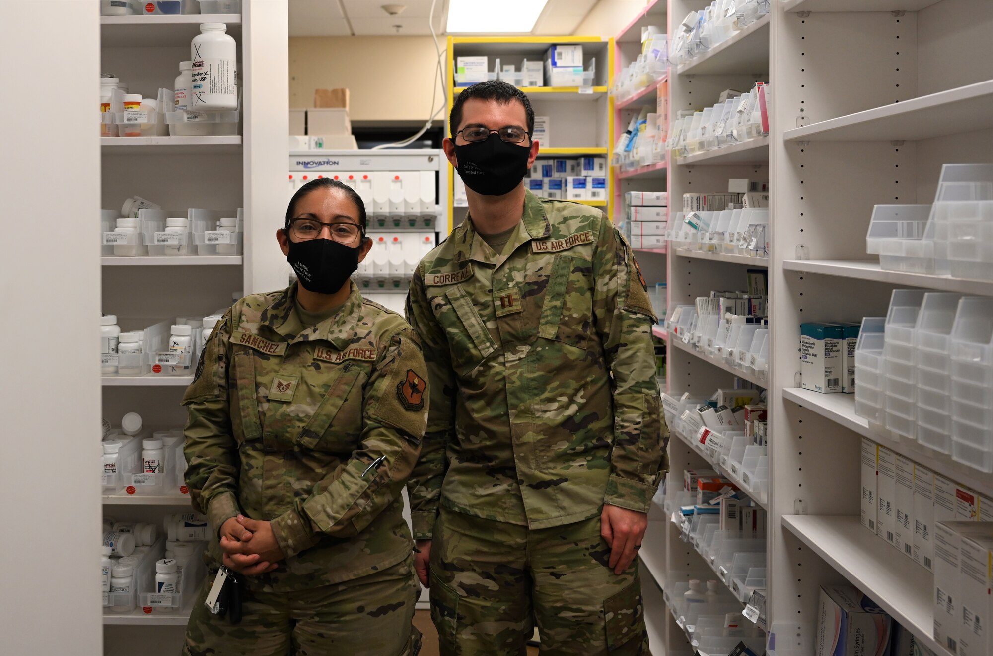 U.S. Air Force Capt. Gregory Correale, 14th Medical Group Pharmacy element chief, and Staff Sgt. Joanna Sanchez, 14th MDG non-commissioned officer in charge of pharmacy services,  pose for a photo in the pharmacy, Nov. 3, 2021, on Columbus Air Force Base, Miss. Both members from the 14th Medical Group were selected to present posters comprised of analytics for pharmacy operations at the virtual National Pharmacy Conference, Oct. 24-26, 2021. (U.S. Air Force photo by Airman 1st Class Jessica Haynie)