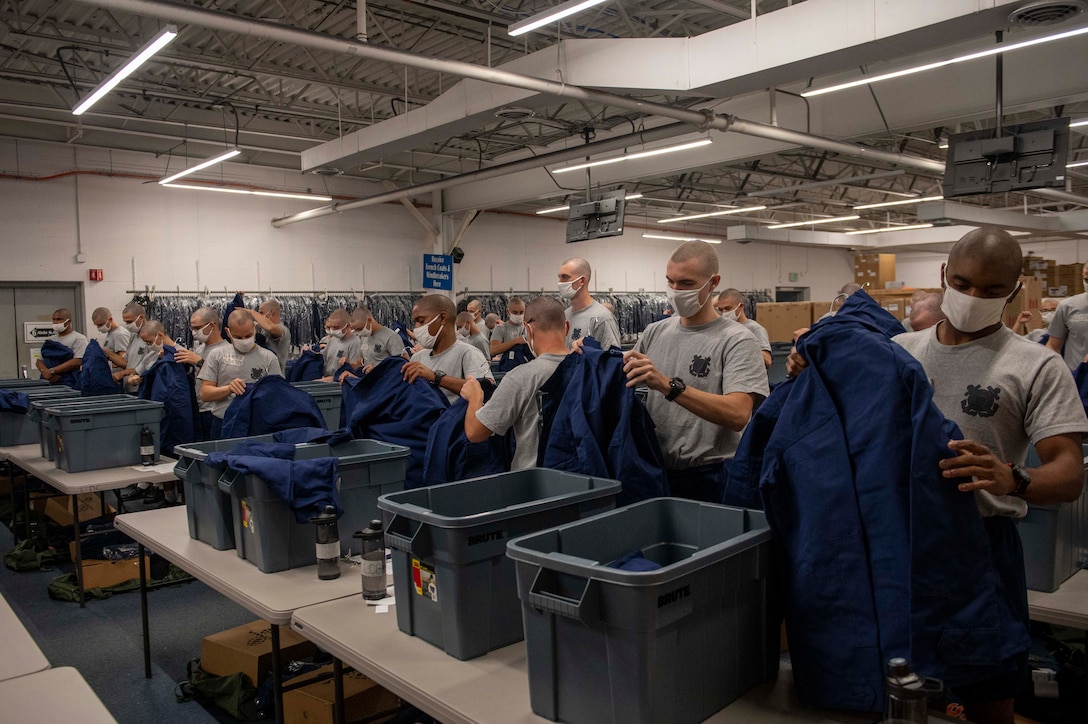 recruits pick up boxes of uniform items