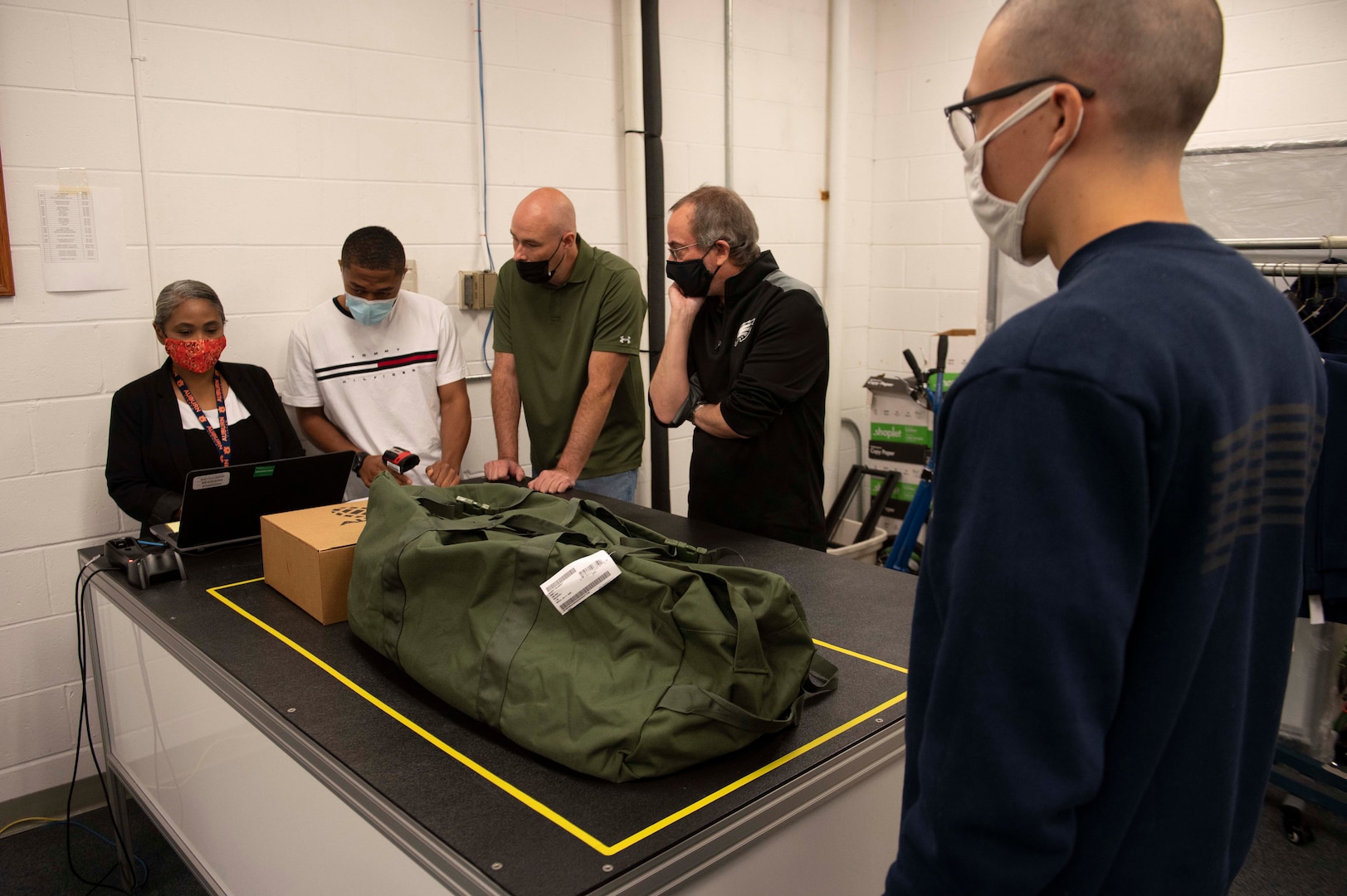recruits pick up boxes of uniform items