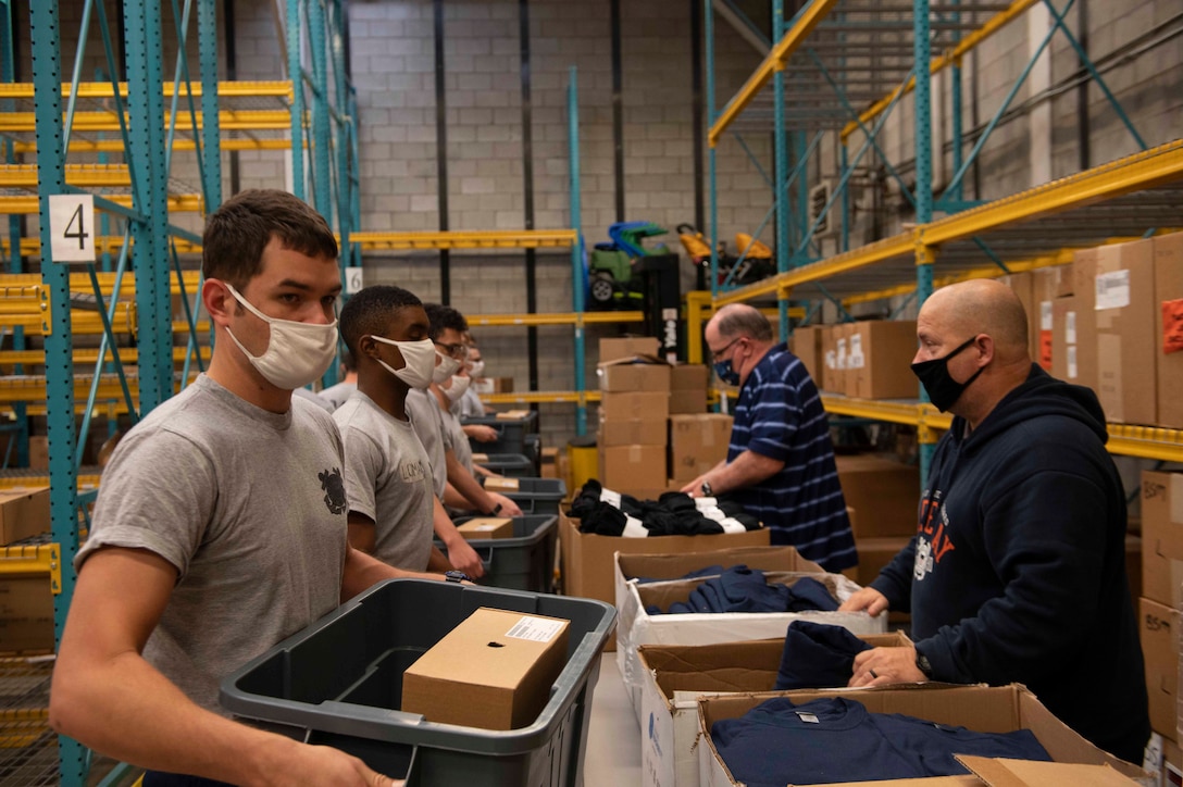 recruits pick up boxes of uniform items