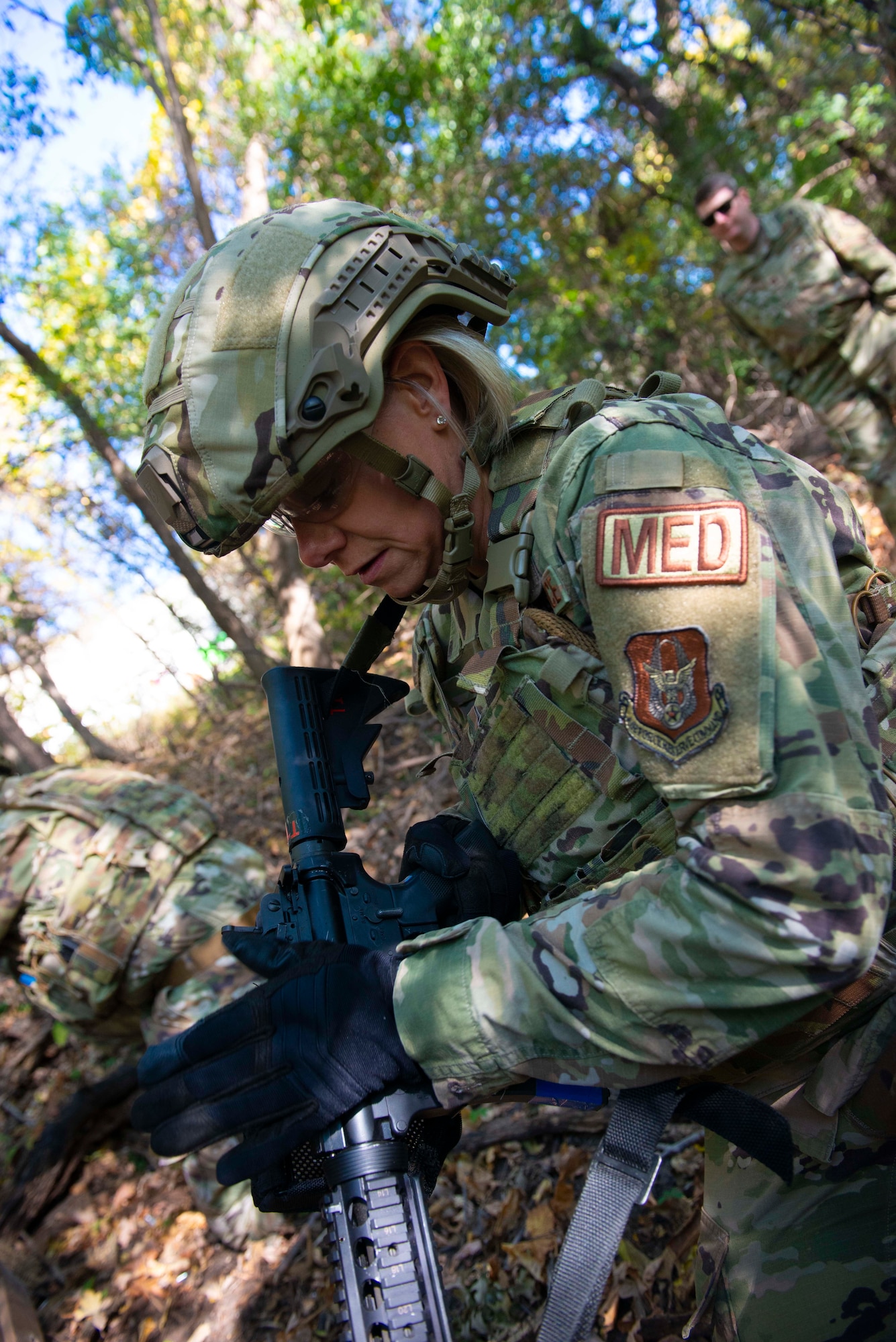 Master Sgt. Danielle Graham, 934th Aeromedical Staging Squadron case manager, performs a function check on her M4 carbine during a shoot, move and communicate exercise on Oct.15, 2021, at the Minneapolis-St. Paul Air Reserve Station, Minn. Airmen were placed in two-person teams with 934th Security Forces Squadron Defenders coaching them through Failure Drills and on how to effectively operate in an austere environment. (U.S. Air Force photo by Chris Farley)